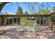 The backyard has a large deck with outdoor seating, mature trees, and a bright exterior at 5450 Mohawk Rd, Littleton, CO 80123