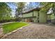 Lush backyard featuring a well-maintained lawn and mature trees, perfect for outdoor activities and relaxation at 5450 Mohawk Rd, Littleton, CO 80123