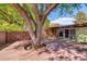 Large backyard with a deck built around a mature tree at 5450 Mohawk Rd, Littleton, CO 80123
