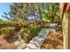 Landscaped backyard with stone steps and lush greenery at 5450 Mohawk Rd, Littleton, CO 80123