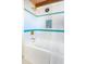 Bright bathroom with a soaking tub featuring contemporary tile accents and gold fixtures at 5450 Mohawk Rd, Littleton, CO 80123
