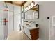Modern bathroom boasts a double sink vanity, sleek lighting, and a walk-in shower at 5450 Mohawk Rd, Littleton, CO 80123