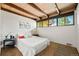 Serene bedroom featuring neutral tones, exposed beams, and ample natural light at 5450 Mohawk Rd, Littleton, CO 80123