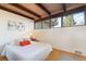 Cozy bedroom with wooden beamed ceiling, bright natural light, and a calm and inviting atmosphere at 5450 Mohawk Rd, Littleton, CO 80123