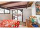 Comfortable bedroom featuring wood beam ceiling with patio access and stylish decor at 5450 Mohawk Rd, Littleton, CO 80123
