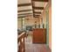 Inviting entryway flows to living room with brick fireplace and exposed beam ceiling at 5450 Mohawk Rd, Littleton, CO 80123