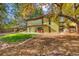 A green two-story home includes a covered patio and well-maintained yard at 5450 Mohawk Rd, Littleton, CO 80123