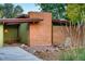 Exterior of home showcases brick facade with modern lines, stone landscaping, and a charming outdoor seating area at 5450 Mohawk Rd, Littleton, CO 80123