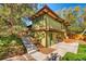 The exterior of this multi-level home has lush landscaping and a patio area at 5450 Mohawk Rd, Littleton, CO 80123
