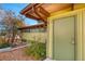 Exterior side view of a green home with a wood awning and a green door at 5450 Mohawk Rd, Littleton, CO 80123