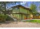 Two-story home with backyard steps to deck and patio seating, offering outdoor relaxation and entertainment at 5450 Mohawk Rd, Littleton, CO 80123