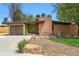 Striking mid-century modern home showcasing a unique design, attached garage, and attractive landscaping at 5450 Mohawk Rd, Littleton, CO 80123