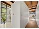 Hallway view of a storage closet and bathroom with sink and large window at 5450 Mohawk Rd, Littleton, CO 80123