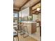 Charming kitchen island with bar stool seating featuring an open design and stainless steel appliances at 5450 Mohawk Rd, Littleton, CO 80123