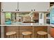 Stylish kitchen island featuring bar stool seating, an open design, stainless steel appliances, and eye-catching views at 5450 Mohawk Rd, Littleton, CO 80123