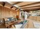 Open-concept living area with wood paneling, sleek furniture, and natural light at 5450 Mohawk Rd, Littleton, CO 80123
