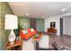Living room featuring a bright orange sofa, unique stone flooring, and stylish mid-century modern decor at 5450 Mohawk Rd, Littleton, CO 80123