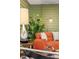 Cozy living room is styled with decor, comfortable seating, and a vibrant green wall at 5450 Mohawk Rd, Littleton, CO 80123