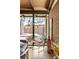 Bright living area featuring large windows, a brick accent wall, and modern decor at 5450 Mohawk Rd, Littleton, CO 80123