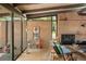 Stylish living room with brick wall, exposed beams, and lots of natural light at 5450 Mohawk Rd, Littleton, CO 80123