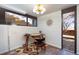 Bright office space with a stylish desk, floor lamp, unique wall decor, and an exterior view at 5450 Mohawk Rd, Littleton, CO 80123