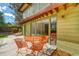 A covered patio includes orange metal table and chairs with sliding glass doors leading into the home at 5450 Mohawk Rd, Littleton, CO 80123