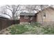 Backyard view showing brick construction with a spacious yard at 3091 S Holly Pl, Denver, CO 80222
