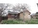 Backyard view featuring a brick home with a new addition under construction at 3091 S Holly Pl, Denver, CO 80222
