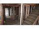 Basement view with framing, electrical work, and a utility area with a refrigerator at 3091 S Holly Pl, Denver, CO 80222