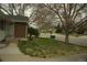 This home features a well-manicured lawn with budding plants and a brick and vinyl exterior at 3091 S Holly Pl, Denver, CO 80222