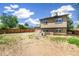 Wide shot of backyard, with fence, grass, and two-story house at 9605 Orangewood Dr, Thornton, CO 80260