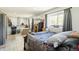Spacious bedroom featuring a comfortable bed, large windows with curtains, and assorted decor at 9605 Orangewood Dr, Thornton, CO 80260