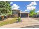 Charming two-story home features a brick facade, well-maintained lawn, and an attached two-car garage at 9605 Orangewood Dr, Thornton, CO 80260