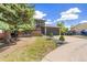 Charming two-story home features a brick facade, well-maintained lawn, and an attached two-car garage at 9605 Orangewood Dr, Thornton, CO 80260