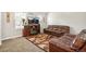 Inviting living room with plush leather seating, fireplace and large windows allowing ample natural light at 9605 Orangewood Dr, Thornton, CO 80260