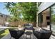 Inviting backyard patio with comfortable seating, a wooden fence, and lush landscaping at 332 S Franklin St, Denver, CO 80209