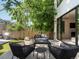 Inviting backyard patio with comfortable seating, a wooden fence, and lush landscaping at 332 S Franklin St, Denver, CO 80209