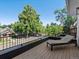 Inviting balcony featuring a cushioned lounge chair and black metal railing with neighborhood views at 332 S Franklin St, Denver, CO 80209