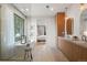 Bright bathroom with a soaking tub, glass shower, dual vanity, and a glimpse of the bedroom at 332 S Franklin St, Denver, CO 80209