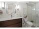 Modern bathroom featuring a sleek vanity, unique mirror, and a glass-enclosed shower at 332 S Franklin St, Denver, CO 80209