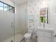 Bright bathroom featuring a glass-enclosed shower and modern vanity at 332 S Franklin St, Denver, CO 80209