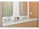 Modern bathroom features a dual vanity with marble countertop, wood cabinets and sleek faucets at 332 S Franklin St, Denver, CO 80209