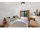 Cozy bedroom features stylish wallpaper, natural light and desk space at 332 S Franklin St, Denver, CO 80209