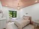 Charming bedroom with a window seat and stylish chandelier at 332 S Franklin St, Denver, CO 80209