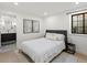 Cozy bedroom with a comfortable queen-size bed, contemporary artwork, and a bright window at 332 S Franklin St, Denver, CO 80209