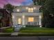 Stunning modern two-story home featuring a covered front porch and second-story balcony with black metal railings at 332 S Franklin St, Denver, CO 80209