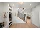 Bright foyer with a staircase, coat closet, and view into the dining and living areas at 332 S Franklin St, Denver, CO 80209