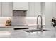 Bright kitchen with modern countertops, stainless steel faucet, and sleek white cabinetry at 332 S Franklin St, Denver, CO 80209