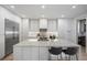 Modern kitchen featuring sleek cabinetry, a large center island with seating, and stainless steel appliances at 332 S Franklin St, Denver, CO 80209