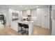 Bright, modern kitchen with an island, sleek cabinetry, stainless steel appliances, and hardwood floors at 332 S Franklin St, Denver, CO 80209